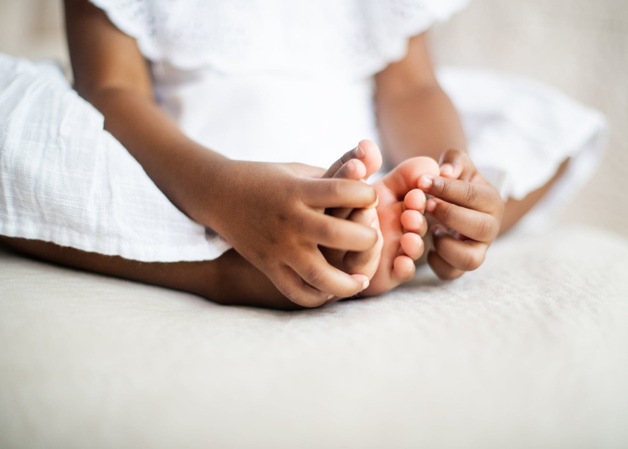 A parent's hands holding a baby's tiny feet