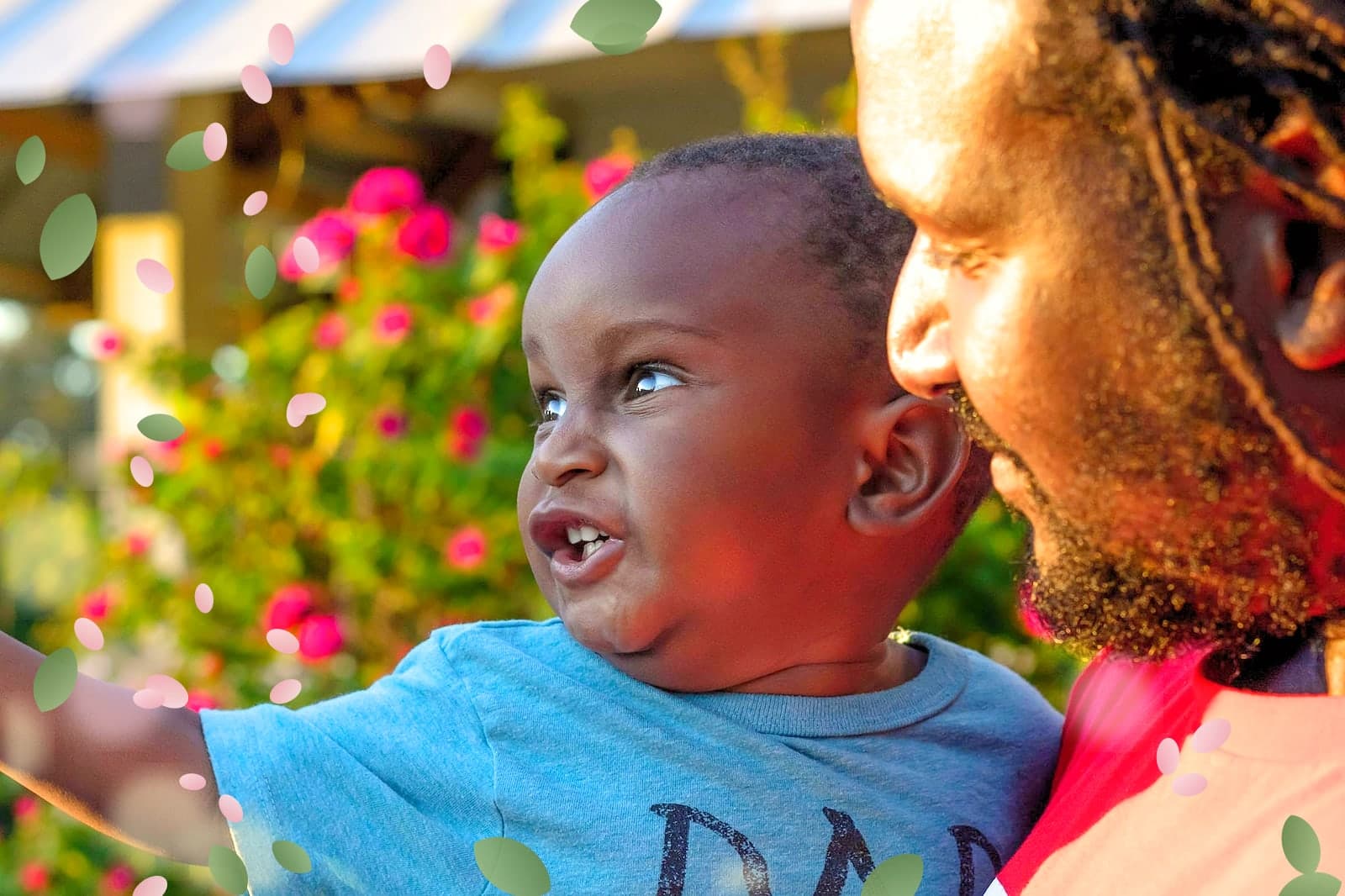 A father and son laughing, in Garden with petals and leaves